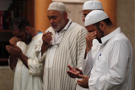 Imams held prayers for three of those killed in Thursday's attack, including 4-year-old Kylan Mejri and his mother Olfa Kalfallah, 31, at the ar-Rahma mosque in the eastern suburb of Ariane in Nice, southern France, Tuesday, July 19, 2016. Mourners rallied around Kylan's father, Tahar, who spoke of his grief at losing his son and wife in the attack. (AP Photo/Francois Mori)