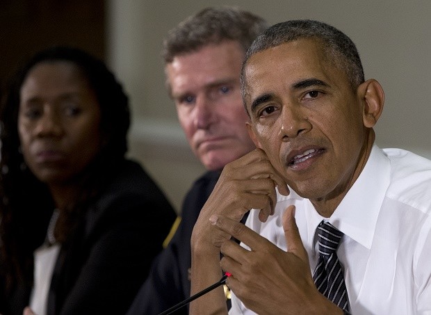 From left, Sherillyn Ifill, President and Director-Counsel of the NAACP Legal Defense and Educational Fund, and Terry Cunningham, President of the International Association of Chiefs of Police, look to President Barack Obama, right, as he speaks to media at the bottom of a meeting at the Eisenhower Executive Office Building on the White House complex in Washington, Wednesday, July 13, 2016, about community policing and criminal justice with a group made of activists, civil rights, faith, law enforcement and elected leaders. AP 