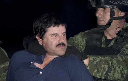 In this Jan. 8, 2016, file photo, Mexican drug lord Joaquin "El Chapo" Guzman is made to face the press as he is escorted to a helicopter in handcuffs by Mexican soldiers and marines at a federal hangar in Mexico City, Mexico. The son of the imprisoned drug lord may be among the half-dozen men abducted by gunmen at a restaurant in the Mexican beach resort of Puerto Vallarta, authorities said Tuesday, Aug 16, 2016. AP