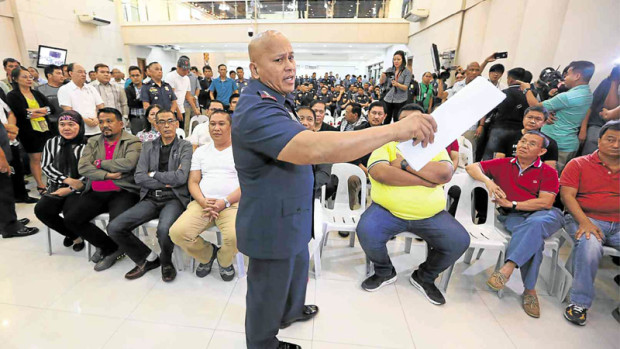 DRESSING DOWN Local government officials and policemen linked by President Duterte to the illegal drug trade get a dressing down from PNP chief Ronald “Bato” dela Rosa in Camp Crame, Quezon City. NIÑO JESUS ORBETA