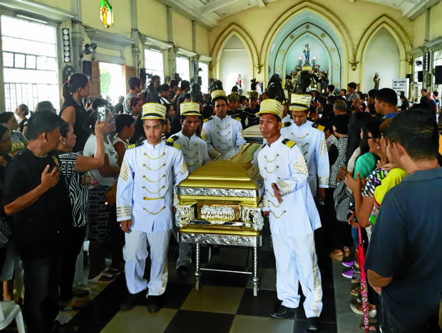 The coffins of Meriam and Melvin Odicta are brought out from the Immaculate Conception Parish Church In Tanza in Iloilo City (Photo by Nestor P. Burgos Jr./INQUIRER VISAYAS)