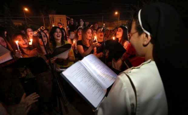 Displaced Iraqi Christians take part in celebrations on October 18, 2016 in Arbil, the capital of the autonomous Kurdish region of northern Iraq, to mark the liberation of Qaraqosh, that was Iraq's largest Christian town before it was overrun by the Islamic State (IS) jihadi group in August 2014. In the south of Iraq, Iraqi forces inching forward along the Tigris river were training their sights on a village called Hammam al-Alil, while units east of Mosul entered Qaraqosh.   / AFP PHOTO / SAFIN HAMED