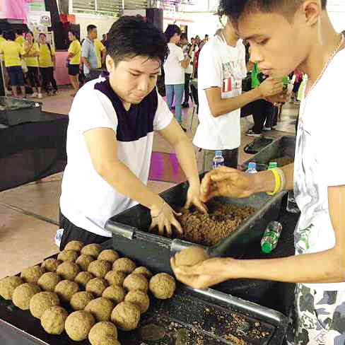 No ordinary mudballs but super mudballs are prepared by residents living near the Taguig River. The mudballs containing good microoganisms are then pitched into the river, releasing microbes to eat up organic waste.  —CONTRIBUTED PHOTO