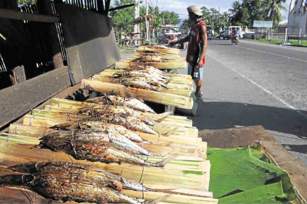 The aroma of grilled fish greets visitors along Dalahican Road in Lucena City.