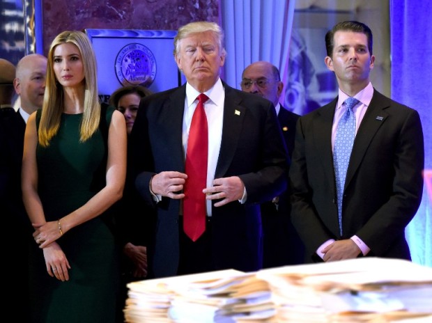 US President- elect Donald Trump stands with his children Ivanka and Donald Jr., during Trump's press conference at Trump Tower in New York on January 11, 2017. / AFP PHOTO / TIMOTHY A. CLARY