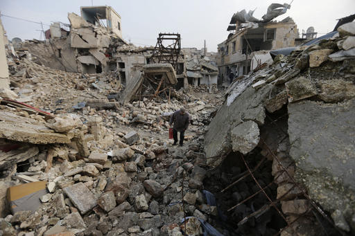 FILE -- In this Jan. 20, 2017 file photo, a resident walks amid the rubble in the once rebel-held Jalloum neighborhood of eastern Aleppo, Syria. Aleppo, Syria’s largest city, was widely brought to ruin by years of war, and now with Russia and Turkey leading peace efforts, international officials say it is time to start talking about rebuilding Aleppo and other cities. But there are few answers on how to do it, with the world reluctant to donate the billions needed and a political settlement in the war still uncertain and far off. (AP Photo/Hassan Ammar, File)