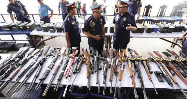 Fifty-six  rifles, 18 pistols, 27 hand grenades, 62 rifle grenades and over 17,000 rounds of ammunition were found inside a “secret room” at  36 Tandang Sora Ave., according to police. —EDWIN BACASMAS