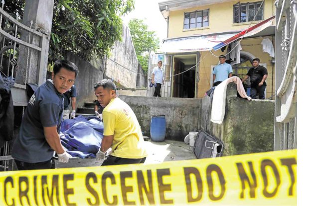 Workers of a funeral parlor bring out a body from the Carlos family house in the City of San Jose del Monte in Bulacan province. Five family members, three of them children, were found dead in the house. —EDWIN BACASMAS