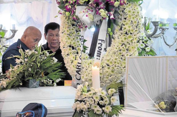 President Duterte and Director General Ronald dela Rosa, Philippine National Police chief, at the wake of members of the Carlos family in the City of San Jose del Monte in Bulacan province —ARNOLD ALMACEN
