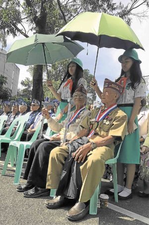 World War II veterans are shielded by umbrellas at a low-key “Victory Day” celebration in Baguio City.  VINCENT CABREZA