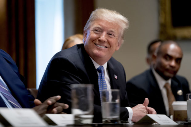 President Donald Trump smiles during a meeting with inner city pastors in the Cabinet Room of the White House in Washington, Wednesday, Aug. 1, 2018. (AP Photo/Andrew Harnik)