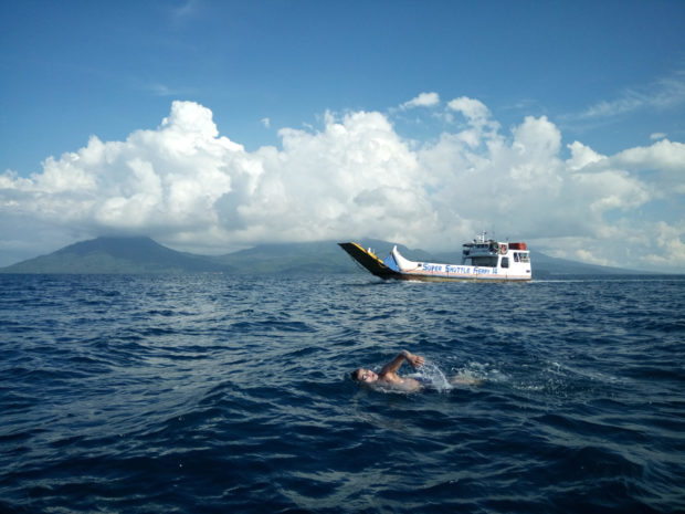 Pinoy Aquaman Ingemar Macarine swims from Camiguin to Misamis Oriental for 7 hours and over 23 kilometers on June 4, 2017, to highlight his call for peace in Mindanao. Image: Leo Udtohan INQUIRER VISAYAS