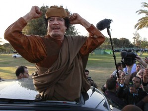 HIS DAYS NUMBERED.  In this April 10, 2011, file photo Libyan leader Moammar Gadhafi gestures to his supporters in Tripoli, Libya. Five months after President Barack Obama told him to leave Libya, Gadhafi is pressing on against NATO-backed rebel forces, flaunting his remaining power in the face of Western nations fearful of combating him with greater force. And four months after Obama offered Syria's leader an ultimatum to lead reform or leave, Bashar Assad's crackdown on dissent rages on. AP Photo/Pier Paolo Cito, File