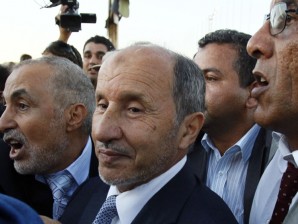 NEW LEADER. Libyan Transitional National Council chairman Mustafa Abdel Jalil, center, flanked with body guards tries to find his way upon his arrival at Metiga airport in Tripoli, Libya, Saturday, Sept. 10, 2011. AP Photo/Francois Mori