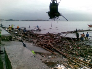 THE DAY AFTER. MMDA personnel use a crane to clean Manila Bay of debris that were washed ashore by strong waves spawned by Typhoon “Pedring” Tuesday, Sept. 27, 2011. ERWIN AGUILON/Radyo Inquirer 990AM