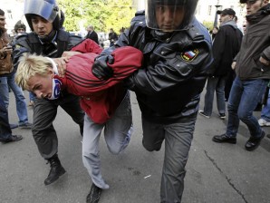Russian police officers detain an anti-gay protester during a gay pride rally in central Moscow, Saturday, Oct. 1, 2011. Saturday's protest was one of the few gay rights events sanctioned by authorities.  AP PHOTO/IVAN SEKRETAREV
