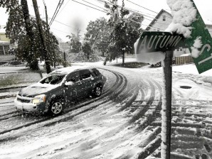  RARE OCCURRENCE. A vehicle makes its way at the snow-covered intersection of Autumn and Grove Streets in Lodi, New Jersey following a rare October snowstorm that hit the region, Saturday, Oct. 29, 2011. AP