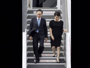 South Korean President Lee Myung-bak, with First Lady Kim Yoon-ok, descends the ramp upon arrival Sunday at Manila's International Airport. Lee is on a three-day state visit in the country (AP Photo/Pat Roque)