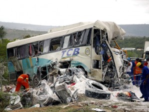 Workers check the rubble of a bus after an accident in Milagres, Brazil's Bahia state, Saturday (December 3, 2011). Brazilian authorities said a tractor-trailer slammed into the bus carrying sugarcane cutters, killing at least 33 people and injuring 13 after the truck driver lost control as he was rounding a corner and heading down a hill early Saturday. AP PHOTO