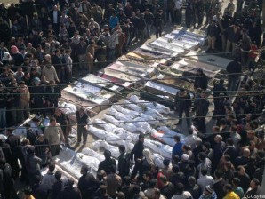 In this citizen journalism image provided by the Local Coordination Committees in Syria, Syrian mourners gather around the coffins of the victims who were killed early Saturday by the bombardment of mortars and rockets during a mass funeral procession, in Khaldiyeh neighborhood in Homs province, central Syria, on Saturday  (Feb. 4, 2012). Activists said more than 200 were killed in the bloodiest episode of the nearly 11-month uprising. (AP Photo/Local Coordination Committees in Syria)