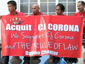 Supporters of Chief Justice Renato Corona hold slogans during the Inter-faith mass and send-off at the Supreme Court grounds, Manila on Tuesday. Corona will testify at the impeachment trial court at the Senate on his alleged dollar accounts.INQUIRER PHOTO / NIÑO JESUS ORBETA