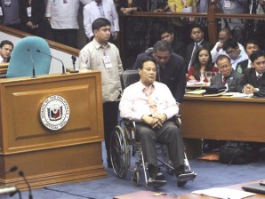 JUSTICE ON WHEELS Corona is wheeled back into the Senate’s session hall after his “walkout.” He’s now confined at The Medical City in Pasig. RAFFY LERMA