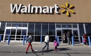 In this Feb. 20, 2012, file photo, customers walk into and out of a Wal-Mart store in Methuen, Mass. Wal-Mart Stores Inc. reported a 10.1 percent increase in first-quarter profit that beat Wall Street estimates, reported Thursday, May 17, 2012. The world’s largest retailer also offered an upbeat profit outlook for the current quarter. (AP Photo/Elise Amendola, File)