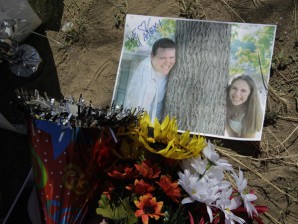 A photograph of theater shooting victim Alex Sullivan and his wife Cassie are shown, Saturday, July 21, 2012, at a memorial near the movie theater in Aurora, Colo.  Twelve people were killed and dozens were injured in the attack early Friday at the packed theater during a showing of the Batman movie, "The Dark Knight Rises."   Police have identified the suspected shooter as James Holmes, 24. (AP Photo/Ted S. Warren)