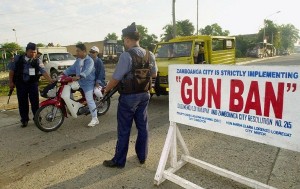 Policemen man a checkpoint to enforce a ban on firearms, along a street in Zamboanga 17 September 2000, as a precaution against the threat of attacks by the Muslim extremist group, Abu Sayyaf, as the military conducts a massive operation against the rebel group on Jolo island. Philippine officials have said that none of the 22 hostages has been injured during the operation, which began early 16 September, against the kidnappers on nearby Jolo island, but soldiers have killed six Abu Sayyaf gunment and captured 20 others. AFP FILE PHOTO/JAY DIRECTO