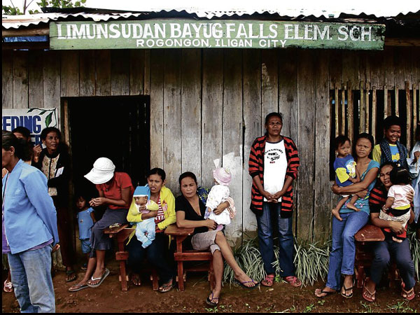 MEMBERS of the Higaonon tribal community gather outside their school in Rogongon, a remote village in Iligan City where teachers refuse to report for work out of fear of being abducted by a group of bandits. RICHEL V. UMEL/INQUIRER MINDANAO