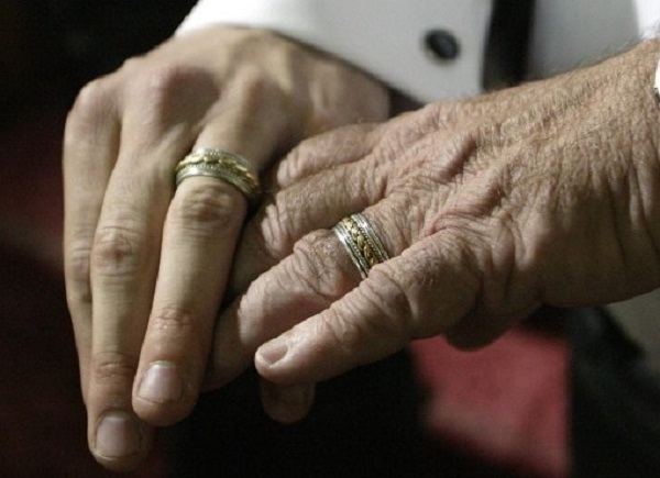 Ric Reed, 30, (L) and Ernest Lacasse, 67, show their wedding rings to the media after their ceremony at the Metropolitan Community Church of Toronto 28 June, 2003 in Toronto, Canada. The Massachusetts Supreme Court ruled 18 November, 2003 that the state's ban on same-sex marriages was unconstitutional. It has given the state legislature 180 days to address their decision. The court's ruling could make Massachusetts the first state to legalize gay marriage. David Lucas/Getty Images/AFP