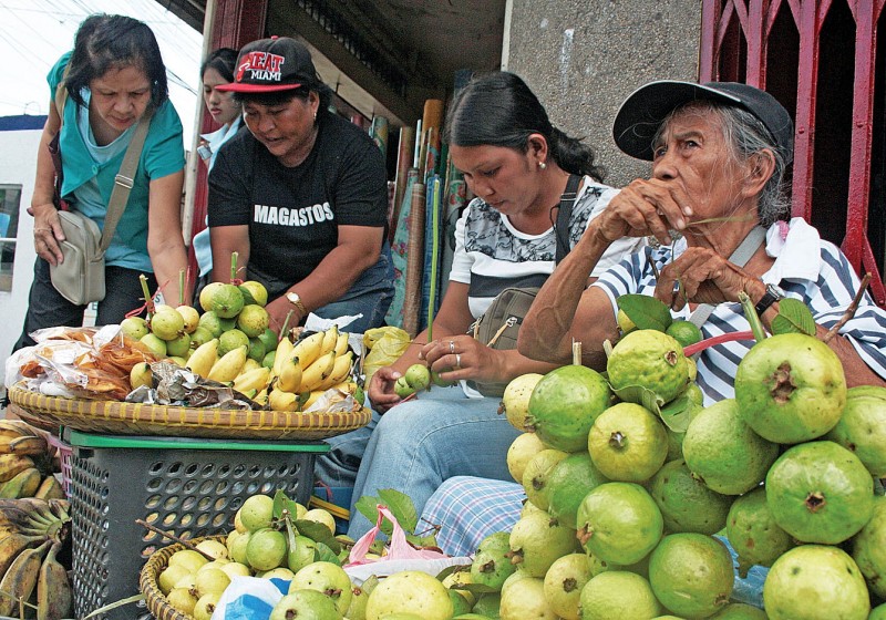 In photo: female vendors selling fruits. The Department of Social Welfare and Development (DSWD) is set to begin implementing the food stamp program in July this year.