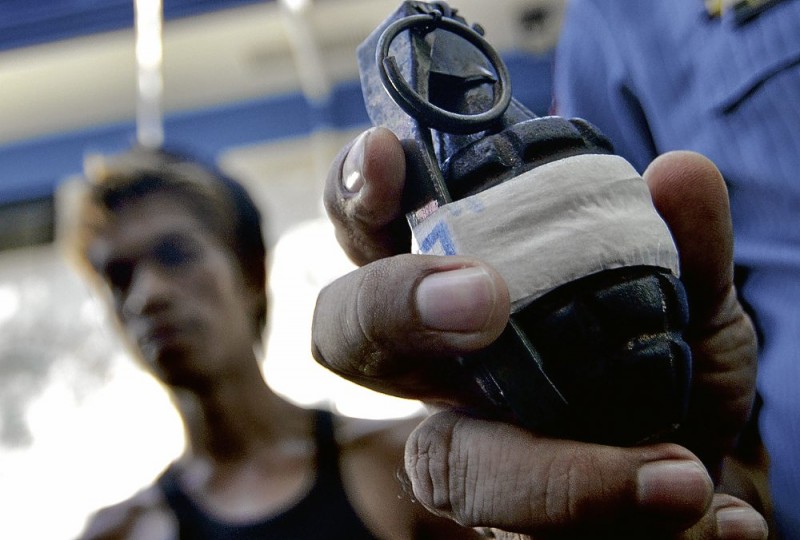 PASAY police chief Senior Supt. Rodolfo Llorca shows the MK2 fragmentation grenade seized from Bernato Daria, a homeless man, who was accosted for urinating in public. Daria, however, claims the grenade was planted by the policemen who arrested him. RICHARD A. REYES