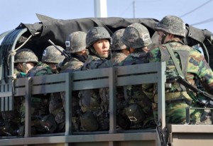 South Korean soldiers ride a military truck on the road leading to North Korea at a military checkpoint in the border city of Paju on Wednesday. South Korea and the United States upgraded their coordinated military surveillance status on April 10, a report said, ahead of an expected mid-range missile launch by North Korea. AFP PHOTO
