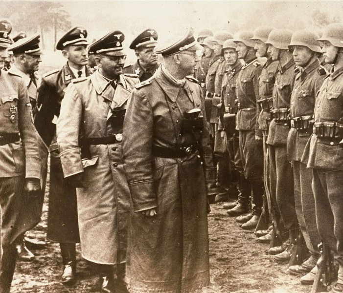 The June 3, 1944 photo provided by the US Holocaust Memorial Museum shows Heinrich Himmler, centre, SS Reichsfuehrer-SS, head of the Gestapo and the Waffen-SS, and Minister of the Interior of Nazi Germany from 1943 to 1945, as he reviews troops of the Galician SS-Volunteer Infantry Division Michael Karkoc a top commander whose Nazi SS-led unit is blamed for burning villages filled with women and children lied to American immigration officials to get into the United States and has been living in Minnesota since shortly after World War II, according to evidence uncovered by The Associated Press. Michael Karkoc became a member of the Galician division after the Ukrainian Self Defense Legion was incorporated into it near the end of the war. AP Photo