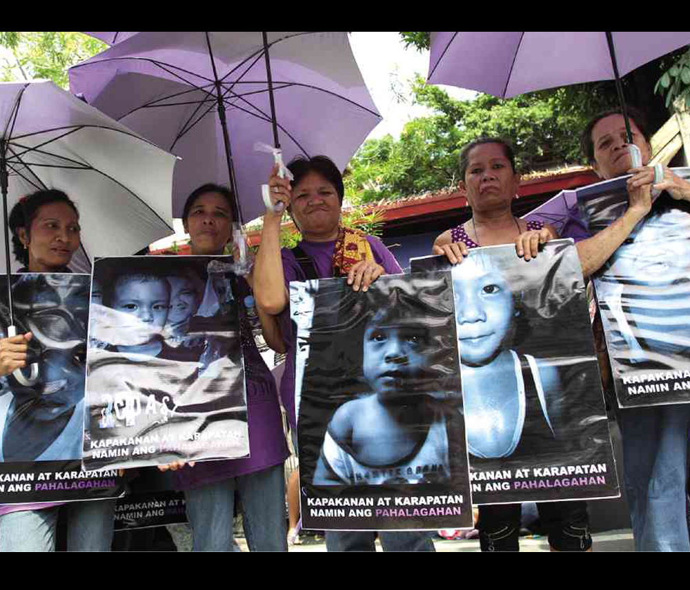 PRO-RH LAW  Proponents of the RH law gather in front of Supreme Court  displaying portraits of poor children.  INQUIRER FILE PHOTO