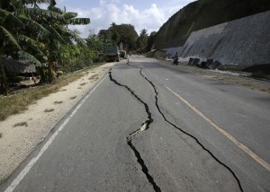 Long cracks on the road caused by a 7.2-magnitude earthquake are visible at Cortes township, Bohol. AP