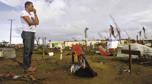 A MAN who survived Supertyphoon “Yolanda” visits the grave of a relative who died at the height of the storm in Palo, Leyte province, as storm survivors continue to struggle for their daily survival amid the toughest of conditions and threats to the flow of relief. RAFFY LERMA 