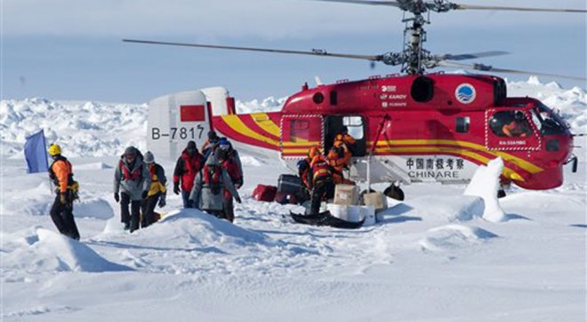 In this image provided by Australasian Antarctic Expedition, A Chinese helicopter arrives to rescue some of the 52 passengers trapped for more than a week on the icebound Russian research ship MV Akademik Shokalskiyin , Thursday, Jan. 2, 2014. AP FILE PHOTO