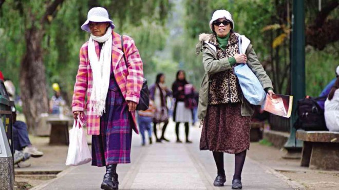BAGUIO WEAR  Elderly women mix and match homemade sweaters with thick snow jackets at Burnham Park in Baguio City. Cooling temperatures have allowed residents to bring out their best winter fashion attire, usually courtesy of secondhand clothes stores.RICHARD BALONGLONG/INQUIRER NORTHERN LUZON