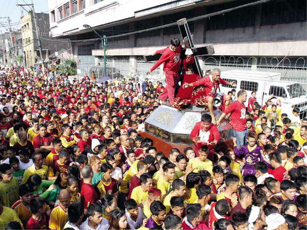 DEVOTEES join a procession for the Black Nazarene in Quiapo, Manila, in this photo taken during last year's feast. INQUIRER FILE PHOTO