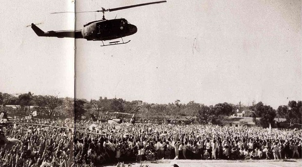 FILE PHOTO: People cheer as one of the attack helicopters, led by then Col. Antonio Sotelo, lands in Camp Crame. The helicopter squadron defected to the rebel soldiers’ side on the second day of the revolt. 