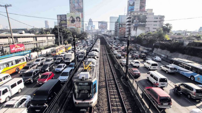Metro Manila road packed with vehicles on both sides, with the railway right in the middle. Road conditions can be symptomatic of a nation's economic growth, or lack of. House Speaker Ferdinand Martin Romualdez observes that some members of the International Monetary Fund appears to be impressed with the country's economic growth and the government's policies for development. 