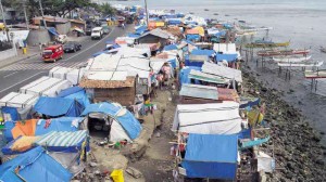 BADJAO EVACUEES  Once a popular promenade, Roseller T. Lim Boulevard in Zamboanga City’s Cawa-Cawa District has become a squalid encampment for seafaring Badjao displaced by the siege of the city by Moro National Liberation Front rebels last September. Disease stalks the camps, inflicting a high mortality rate, particularly among children.  EDWIN BACASMAS