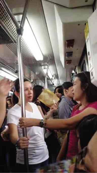 Senator Grace Poe rides the MRT Friday and takes note of the riders’ daily travails ahead of the Senate inquiry this week into the state of the public transport system. photo: Office of Sen. Grace Poe 