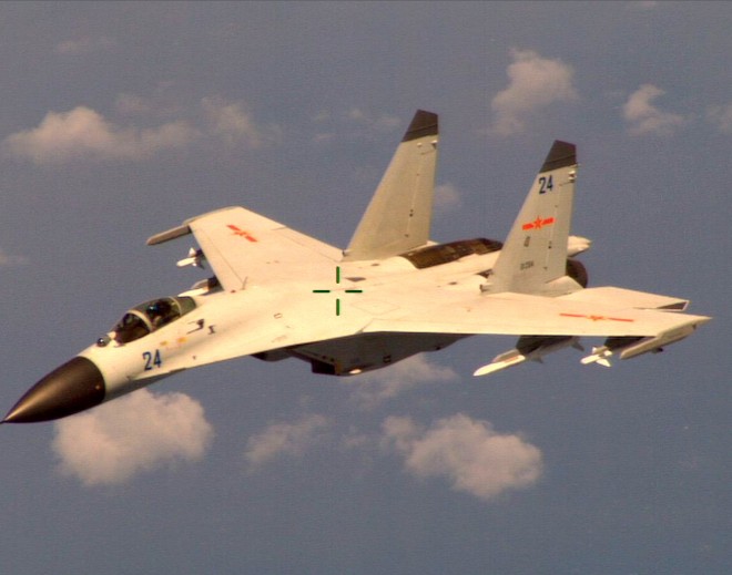 This handout photo provided by the Office of the Defense Secretary (OSD), taken Aug. 19, 2014, shows a Chinese fighter jet that the Obama administration said Friday conducted a "dangerous intercept" of a U.S. Navy surveillance and reconnaissance aircraft off the coast of China in international airspace. AP 