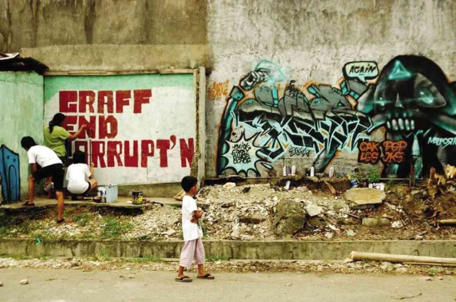 GRAFFITI and street artists in Laguna daub an empty wall in Los Baños, Laguna, to protest corruption in the government.  BENJIE VILLARUEL/CONTRIBUTOR 