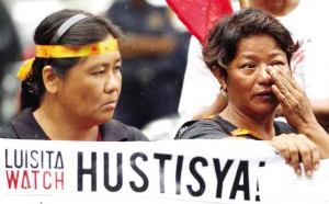 VIOLETA Basilio (right) weeps during the protest action for the victims of the 2004 Hacienda Luisita Massacre where several sugar workers, including her only son Jhaivie, died during the bloody dispersal. LYN RILLON/INQUIRER FILE PHOTO