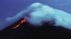 FILE PHOTO: Hot glowing lava cascades down Mayon Volcano in this shot taken from Legazpi City in Albay province. Authorities have evacuated thousands of residents at the foot of the country’s most active volcano in anticipation of a possible deadly eruption within weeks, according to Phivolcs. Safe areas for viewing have been designated for tourists who are expected to come in droves like in the 2009 eruption.  AFP