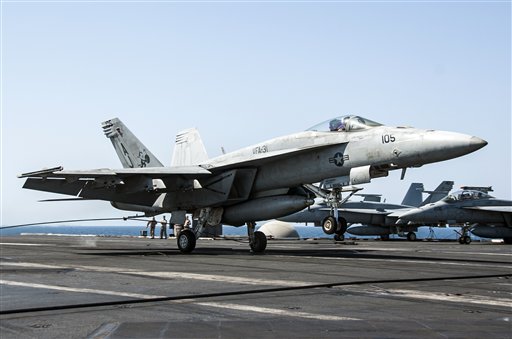  In this file image provided by the U.S. Navy on Tuesday, Sept. 23, 2014, a F/A-18E Super Hornet attached to the Tomcatters of Strike Fighter Squadron (VFA) 31 lands aboard the aircraft carrier USS George H.W. Bush after conducting strike missions against Islamic State group and other targets in Syria.  AP